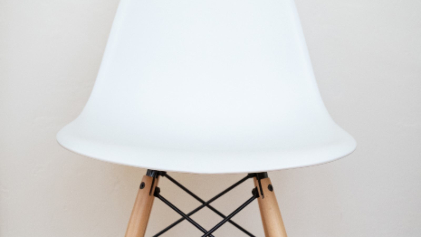 A chair against a plain, evenly lit wall, the kind of bare surface the unit projects onto